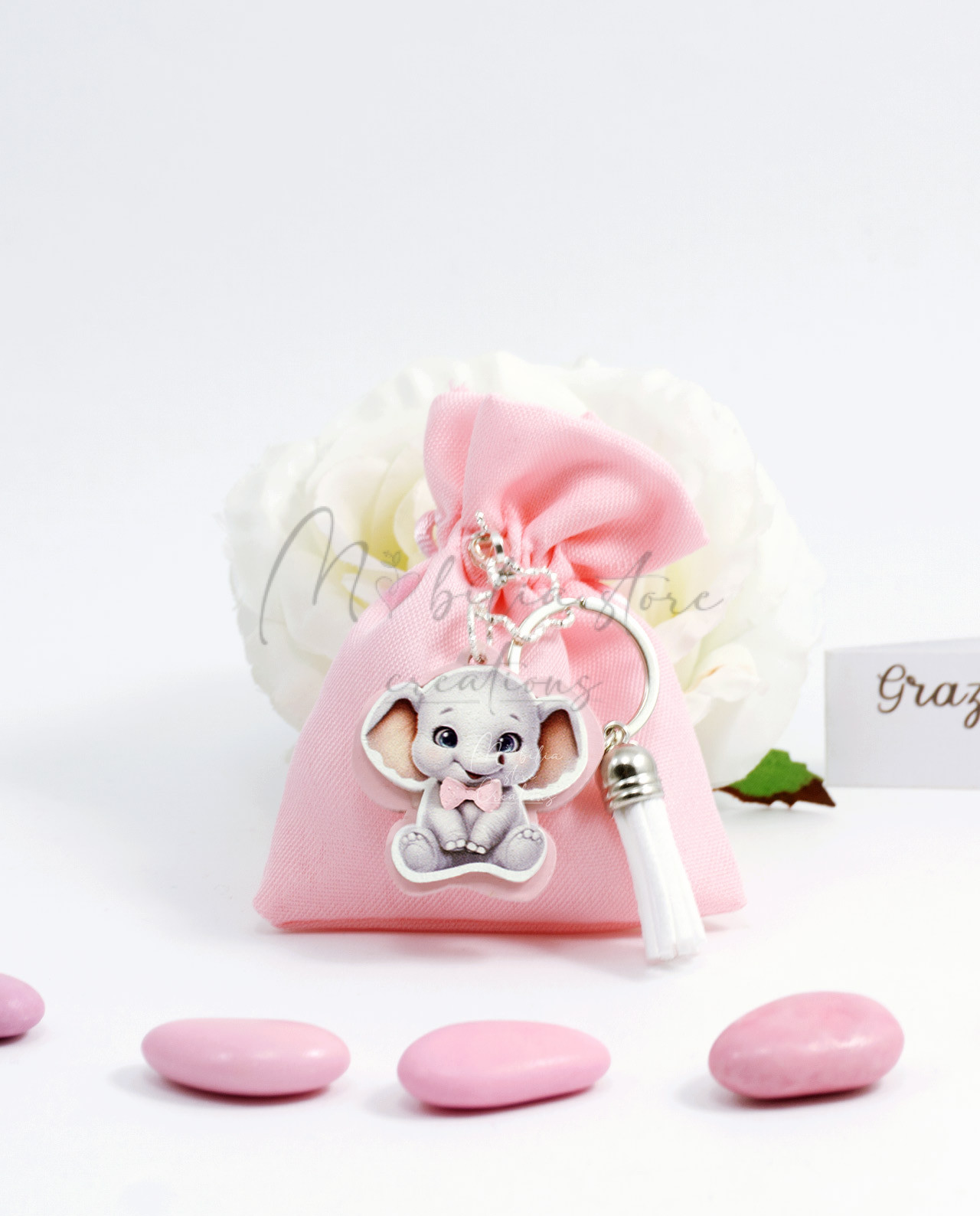 Sacchetto rosa con portachiavi orsetto e elefante con confetti